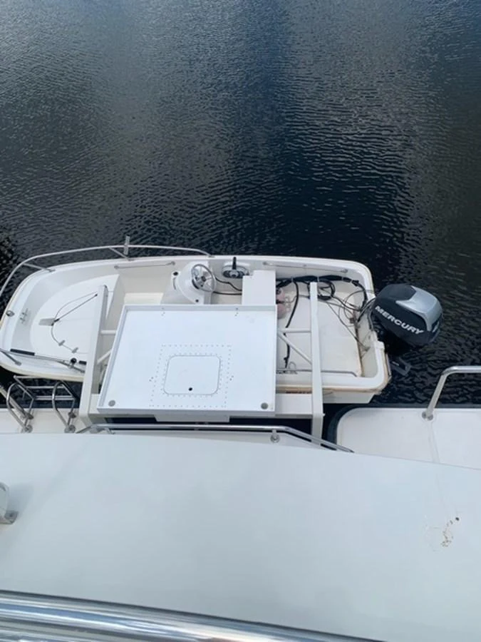 A small tender boat is secured on the yacht's deck, ready for use. aboard THE CAT FROM THE HAT Yacht for Sale
