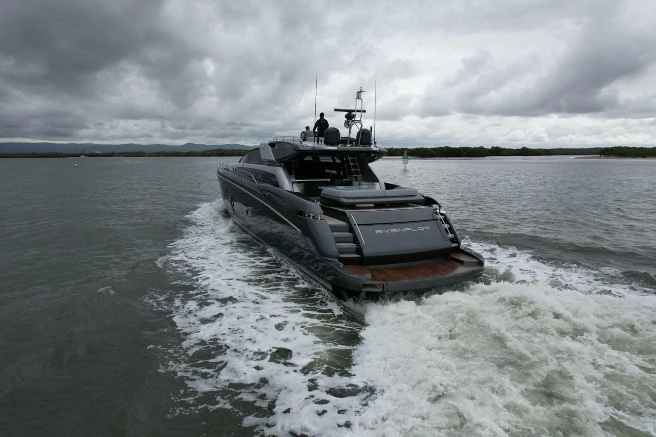 A sleek yacht cruises through calm waters under a cloudy sky. aboard EVENFLOW Yacht for Sale