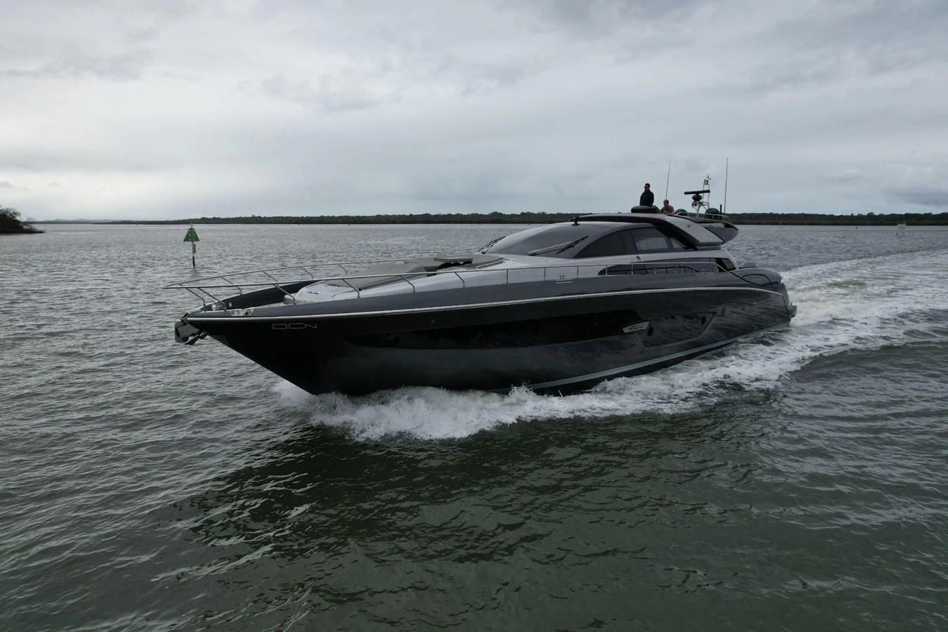 A sleek, modern yacht cruises through calm waters under an overcast sky. aboard EVENFLOW Yacht for Sale