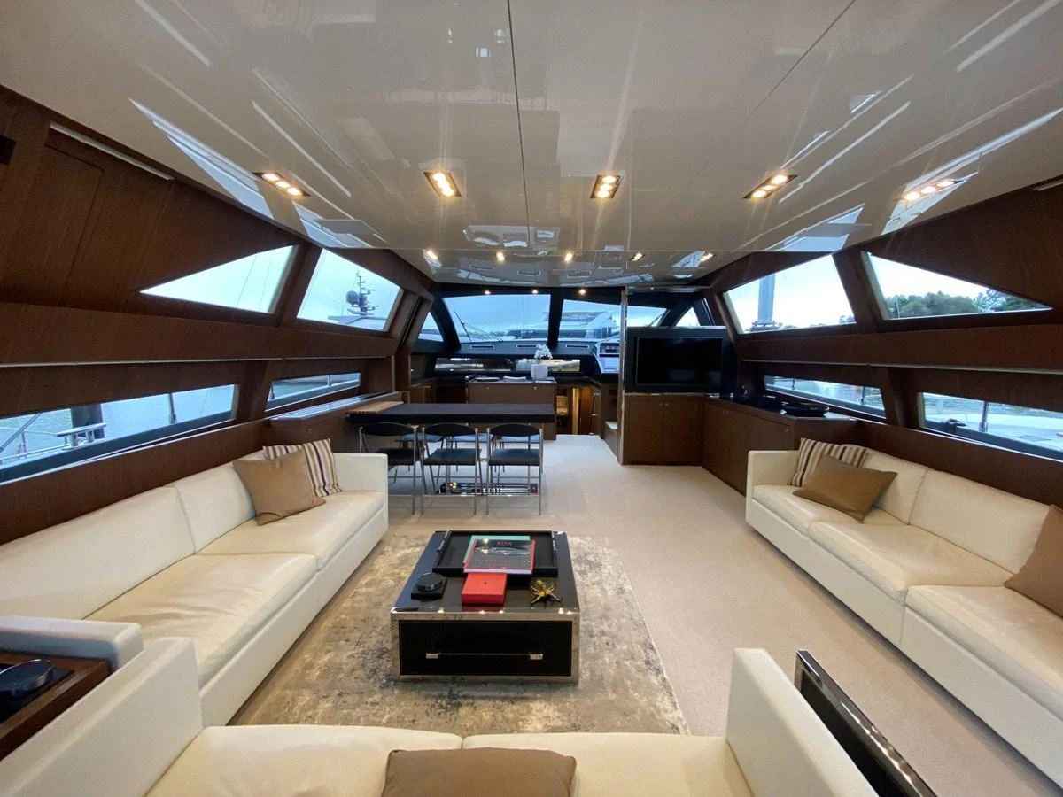The yacht's salon features luxurious seating, a dining area, and panoramic windows for an elegant and spacious ambiance. aboard EVENFLOW Yacht for Sale
