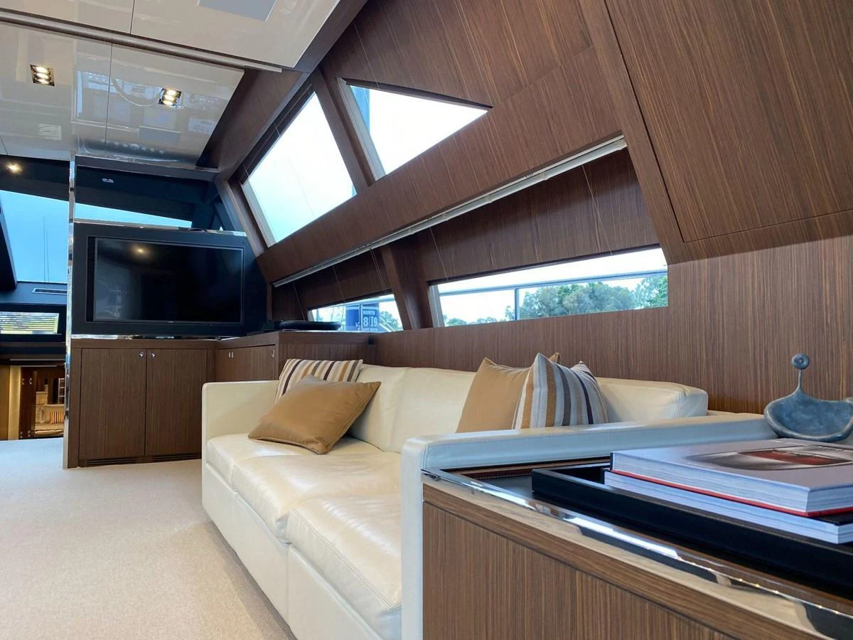 The salon features a comfortable seating area with large windows providing ample natural light. aboard EVENFLOW Yacht for Sale