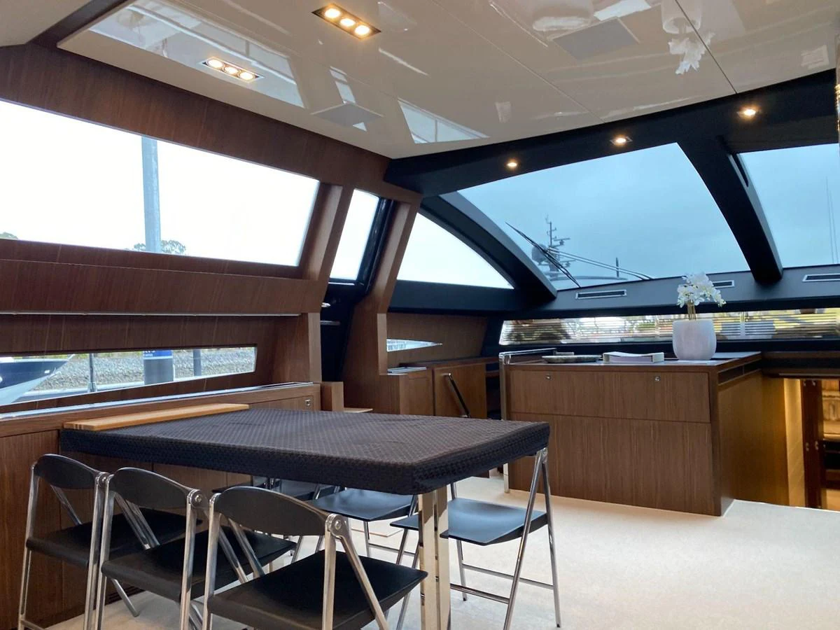 The yacht's dining area features modern furnishings and expansive windows for a luxurious dining experience. aboard EVENFLOW Yacht for Sale