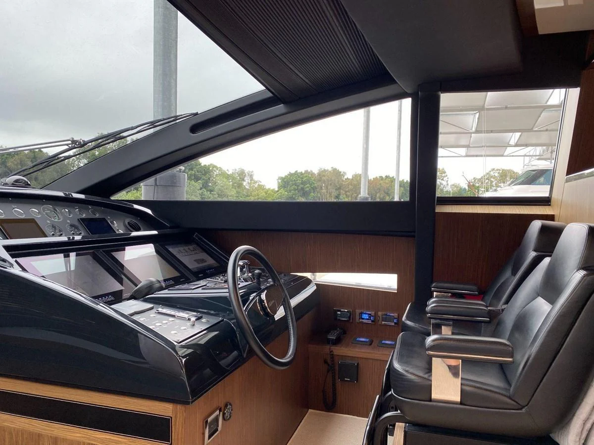 The helm station features modern navigation equipment and comfortable seating, offering a commanding view for the captain. aboard EVENFLOW Yacht for Sale