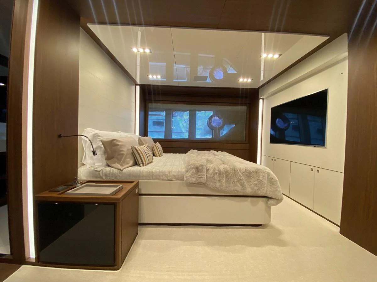 A luxurious stateroom featuring a large bed, modern lighting, and ample storage space. aboard EVENFLOW Yacht for Sale