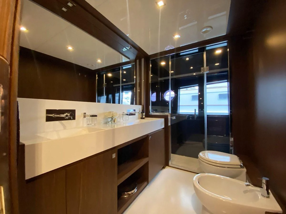 The yacht's bathroom features a sleek design with modern fixtures and ample lighting. aboard EVENFLOW Yacht for Sale
