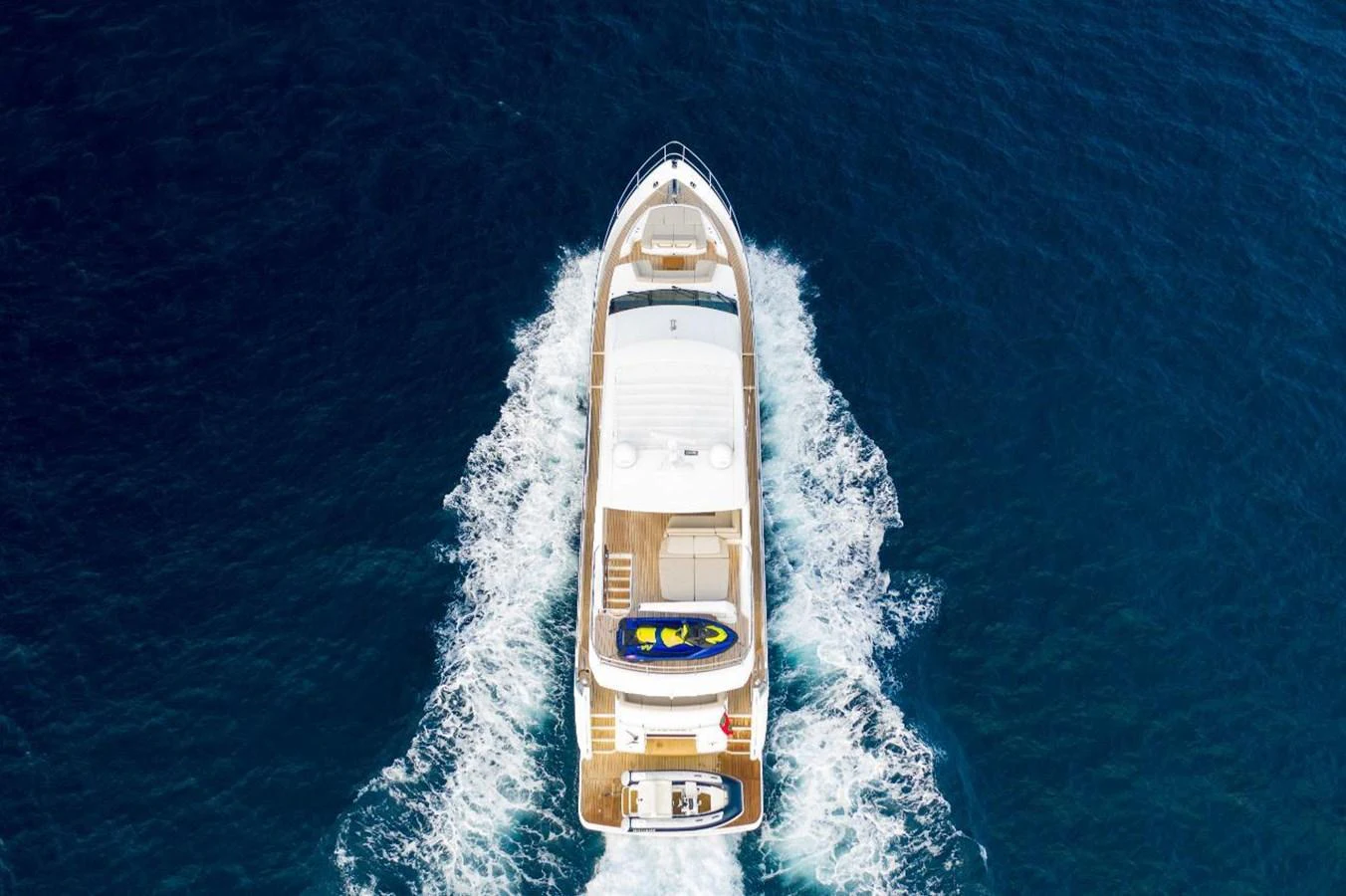 Aerial view of a luxurious yacht cruising through the open sea, showcasing its elegant design and spacious deck. aboard RAGARDA Yacht for Sale