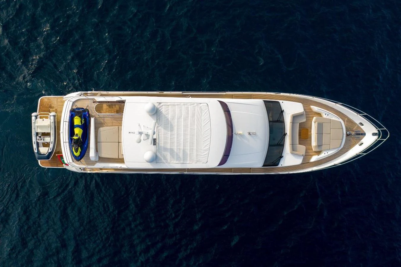 An aerial view of a luxurious yacht cruising on deep blue waters. aboard RAGARDA Yacht for Sale