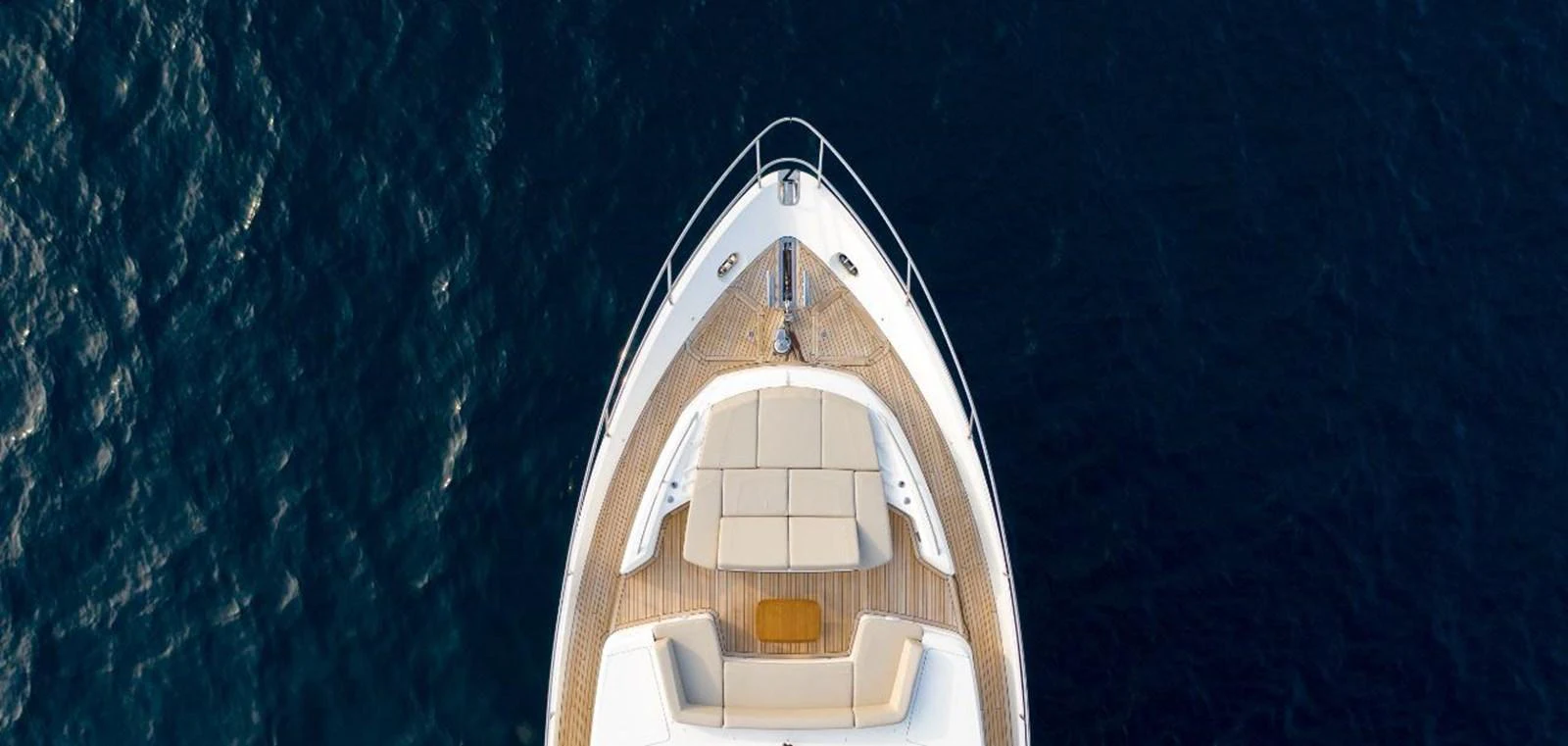 An aerial view of the yacht's bow, showcasing a spacious sunbathing area with plush cushions. aboard RAGARDA Yacht for Sale