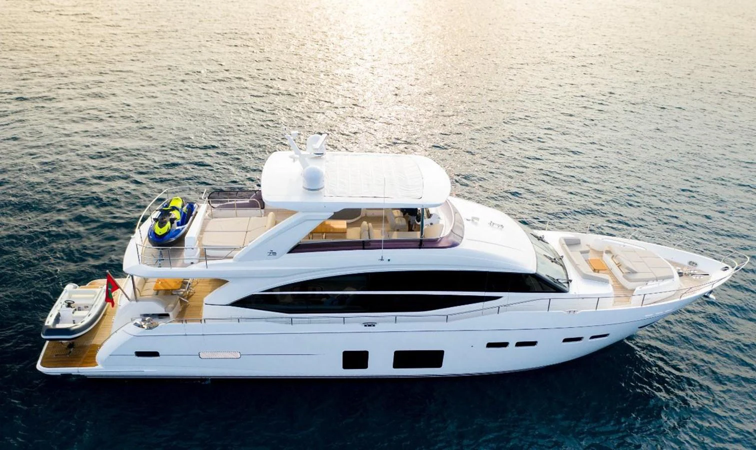 A sleek and modern yacht glides gracefully on calm waters at sunset. aboard RAGARDA Yacht for Sale