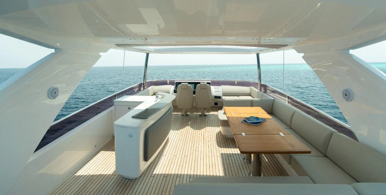 The flybridge offers a spacious and luxurious area with ample seating and a dining table, perfect for enjoying the ocean views. aboard RAGARDA Yacht for Sale