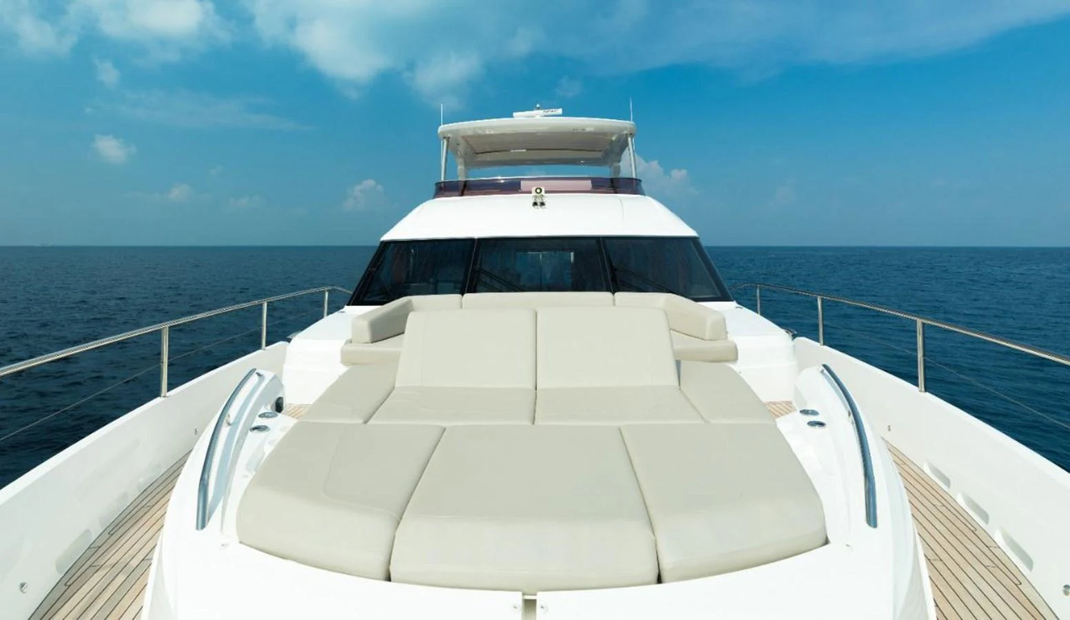 The yacht's foredeck features luxurious sun pads with a stunning ocean backdrop. aboard RAGARDA Yacht for Sale