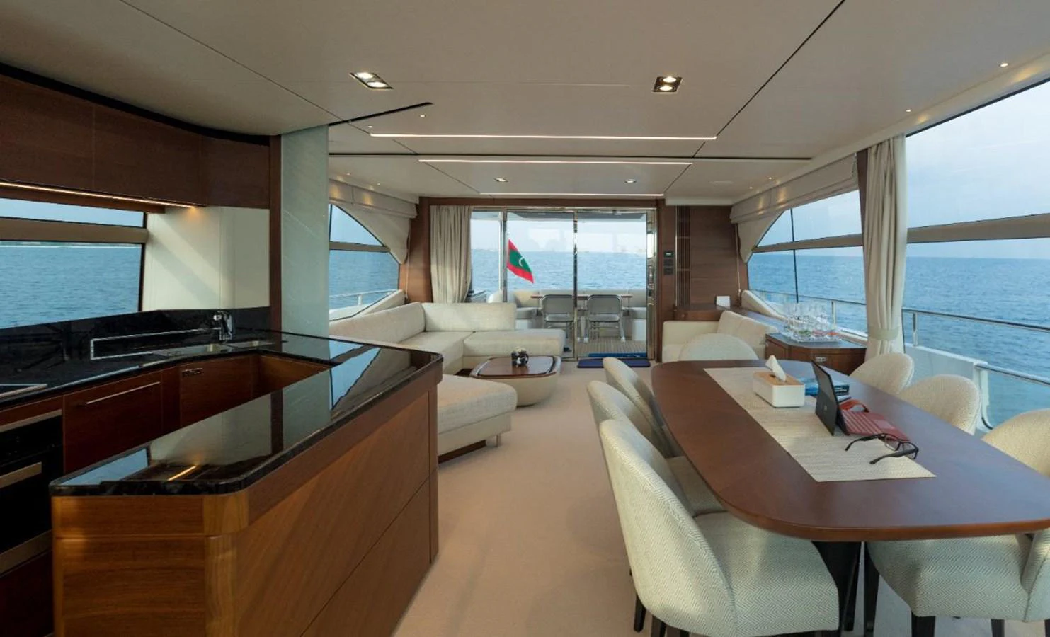 The spacious salon offers a luxurious setting with panoramic views and elegant furnishings. aboard RAGARDA Yacht for Sale