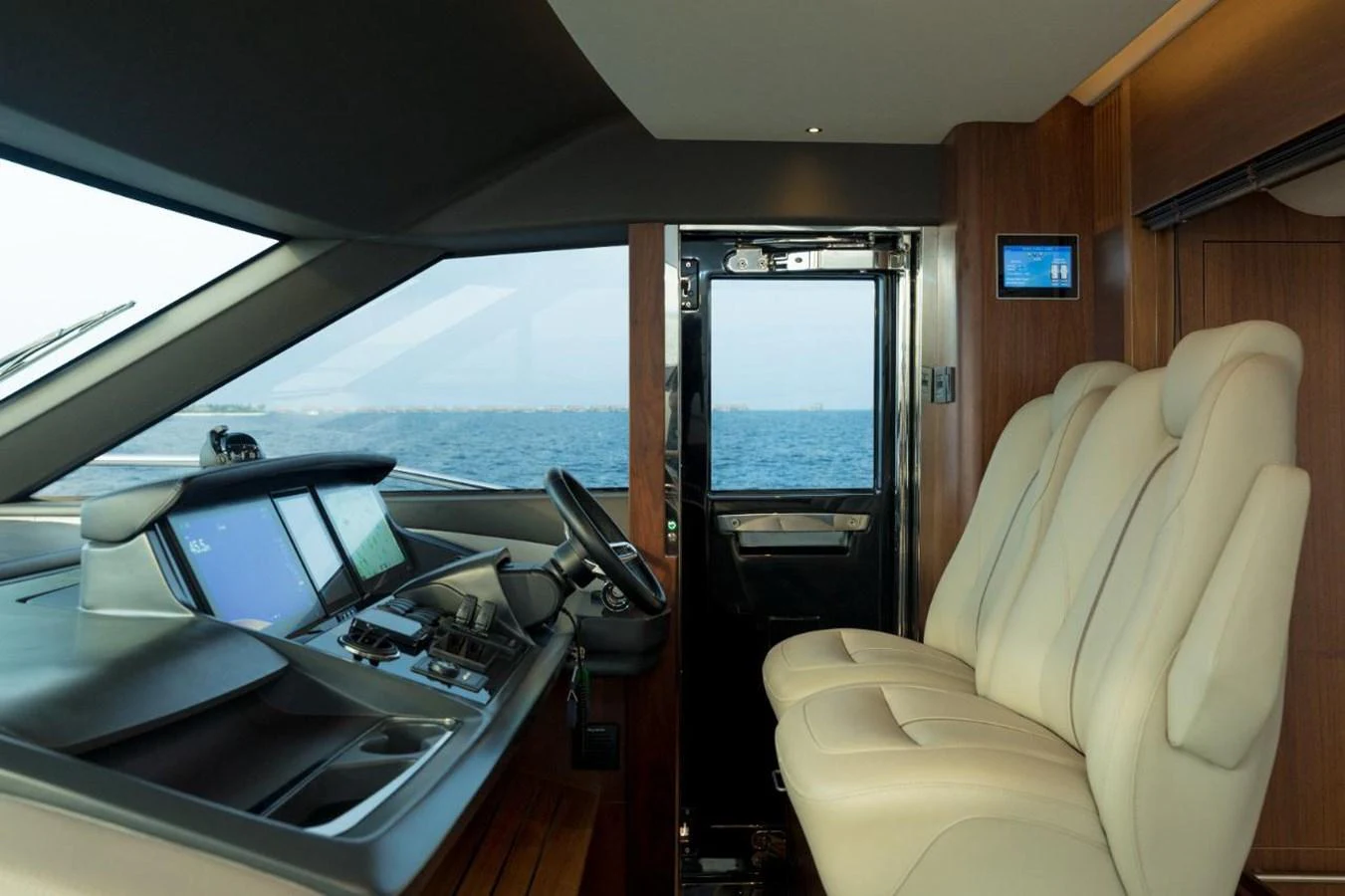 The helm station features modern navigation equipment and comfortable seating with a view of the sea. aboard RAGARDA Yacht for Sale