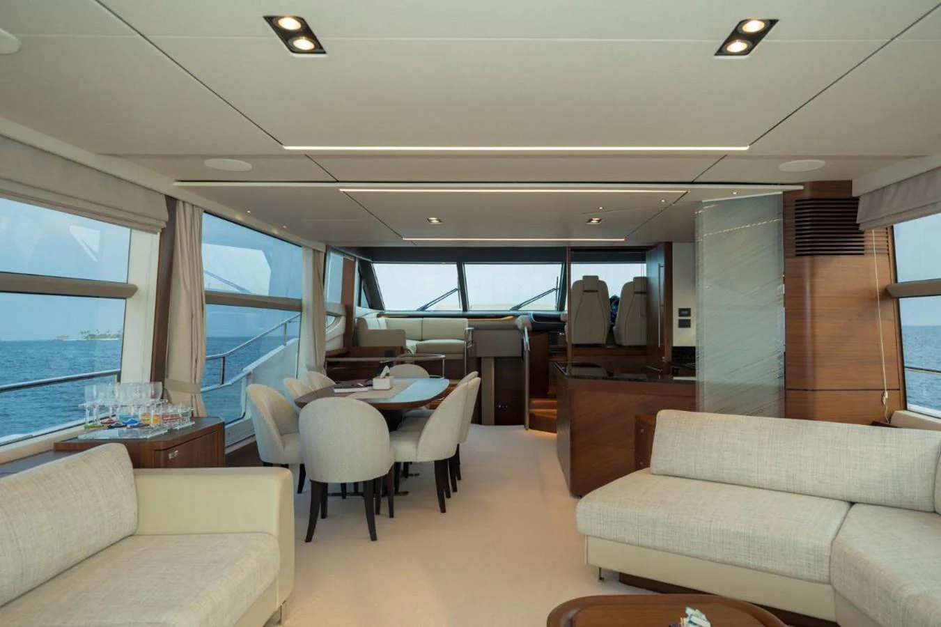 The yacht's salon features elegant seating, a dining area, and large windows offering panoramic views. aboard RAGARDA Yacht for Sale