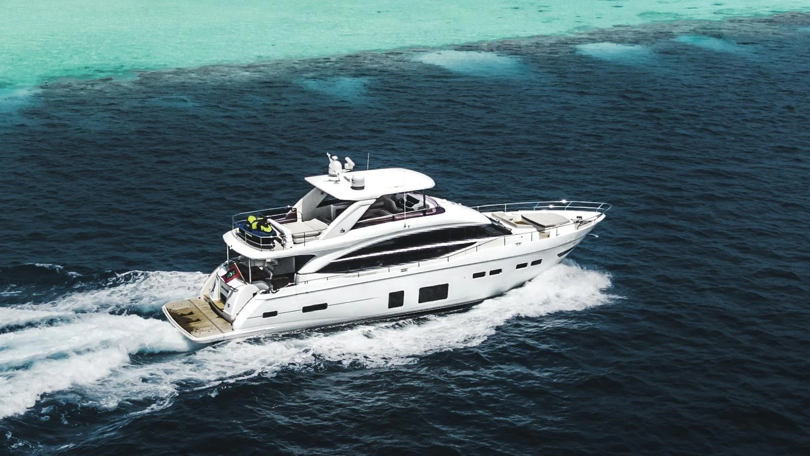 A sleek and modern yacht cruises through clear blue waters, showcasing its elegant design and spacious decks. aboard RAGARDA Yacht for Sale