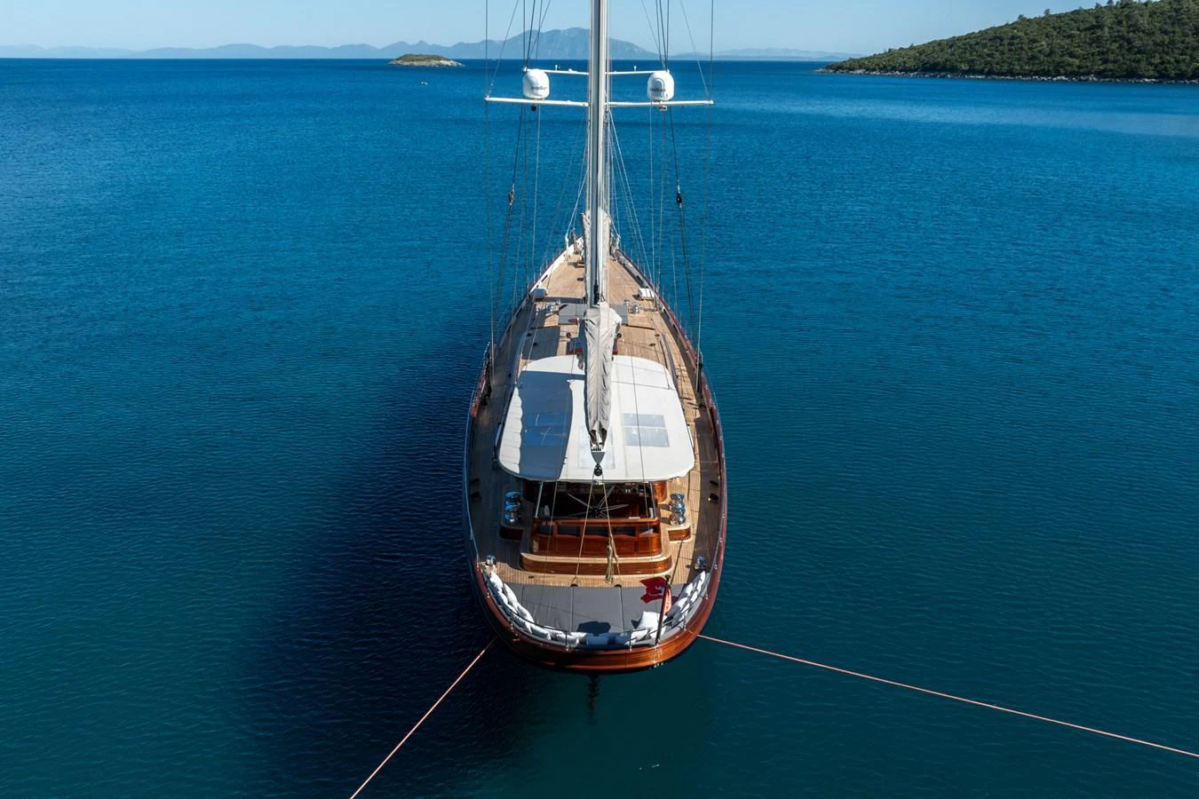 A stunning yacht anchored in serene blue waters, viewed from above. aboard SALLYNA Yacht for Sale