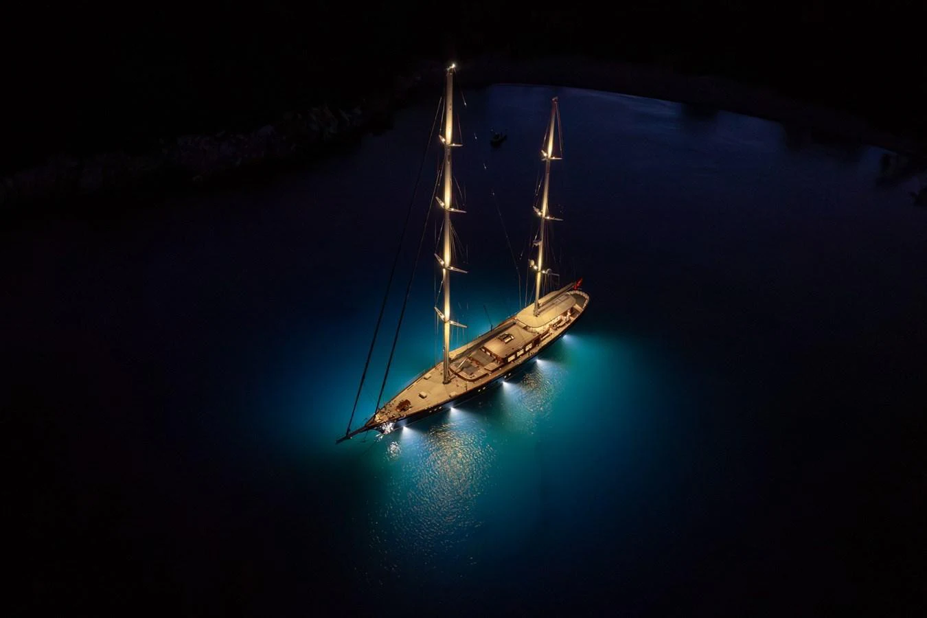 A stunning yacht illuminated at night, showcasing its elegant design and serene surroundings. aboard SALLYNA Yacht for Sale