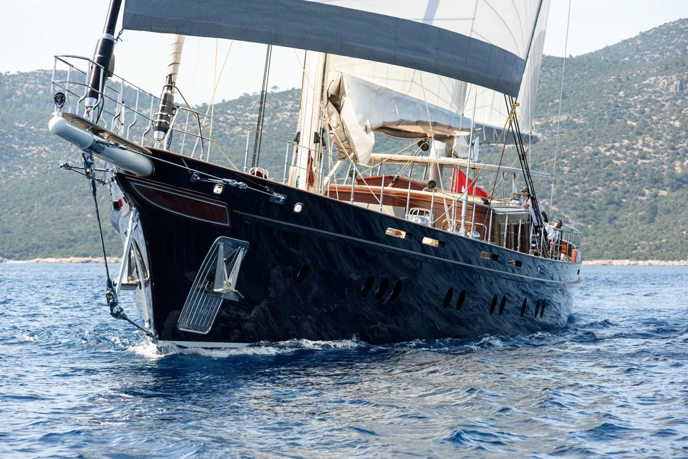 A sleek sailing yacht glides gracefully through the water with its sails unfurled. aboard SALLYNA Yacht for Sale