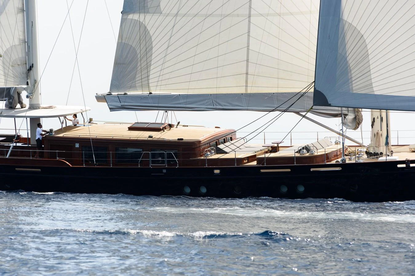 A sleek sailing yacht glides gracefully over the water with its sails fully extended. aboard SALLYNA Yacht for Sale