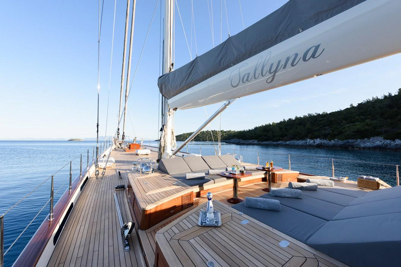 The spacious deck offers luxurious lounging areas with stunning views of the surrounding waters. aboard SALLYNA Yacht for Sale