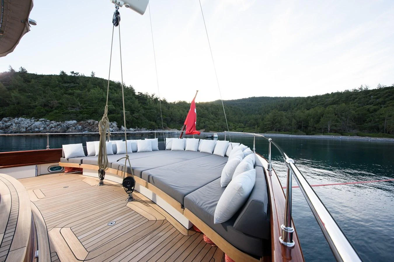 The sundeck features a spacious lounging area with plush cushions, perfect for relaxation while enjoying scenic views. aboard SALLYNA Yacht for Sale