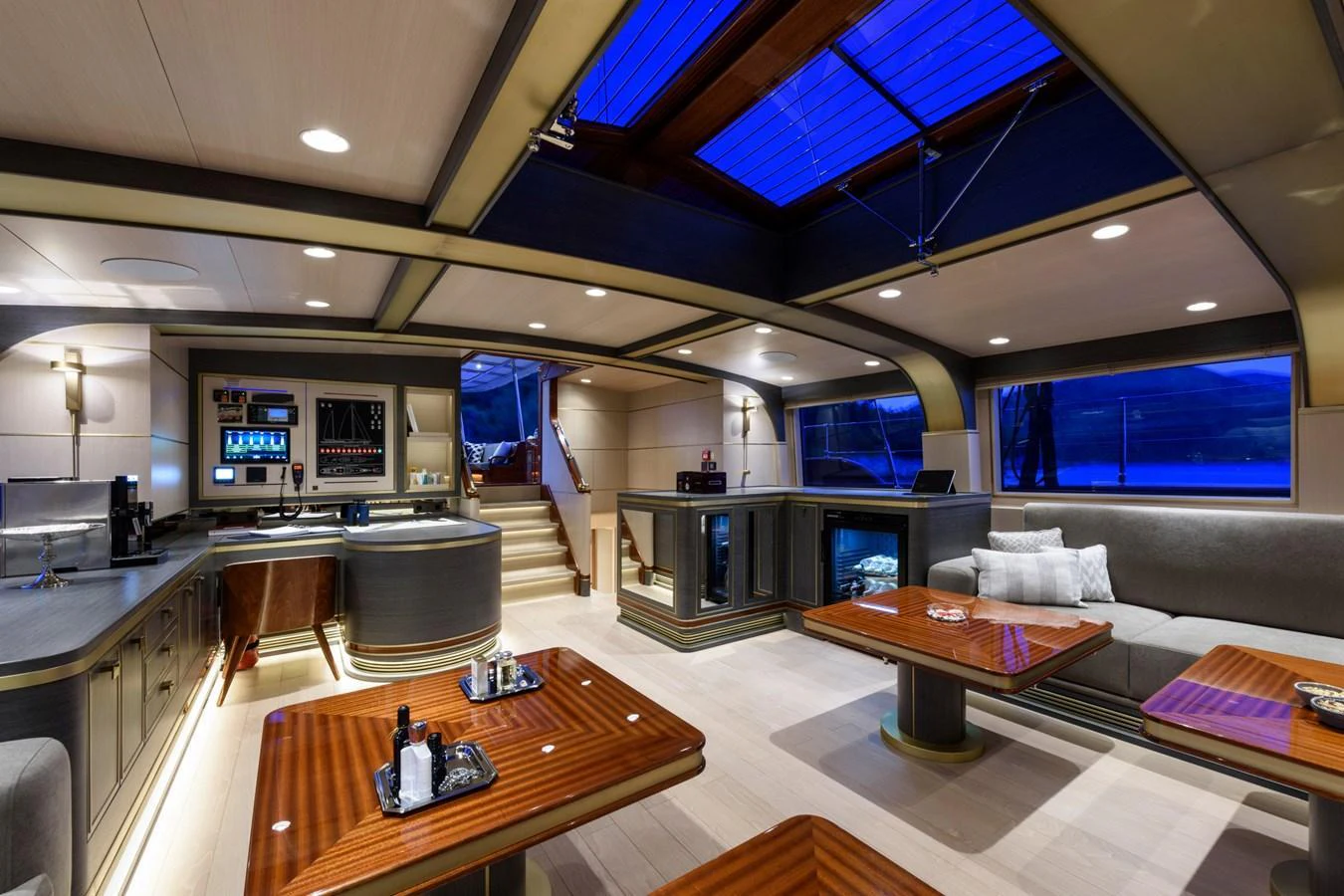 The yacht's salon features elegant furnishings and a sophisticated ambiance, highlighted by a skylight ceiling. aboard SALLYNA Yacht for Sale