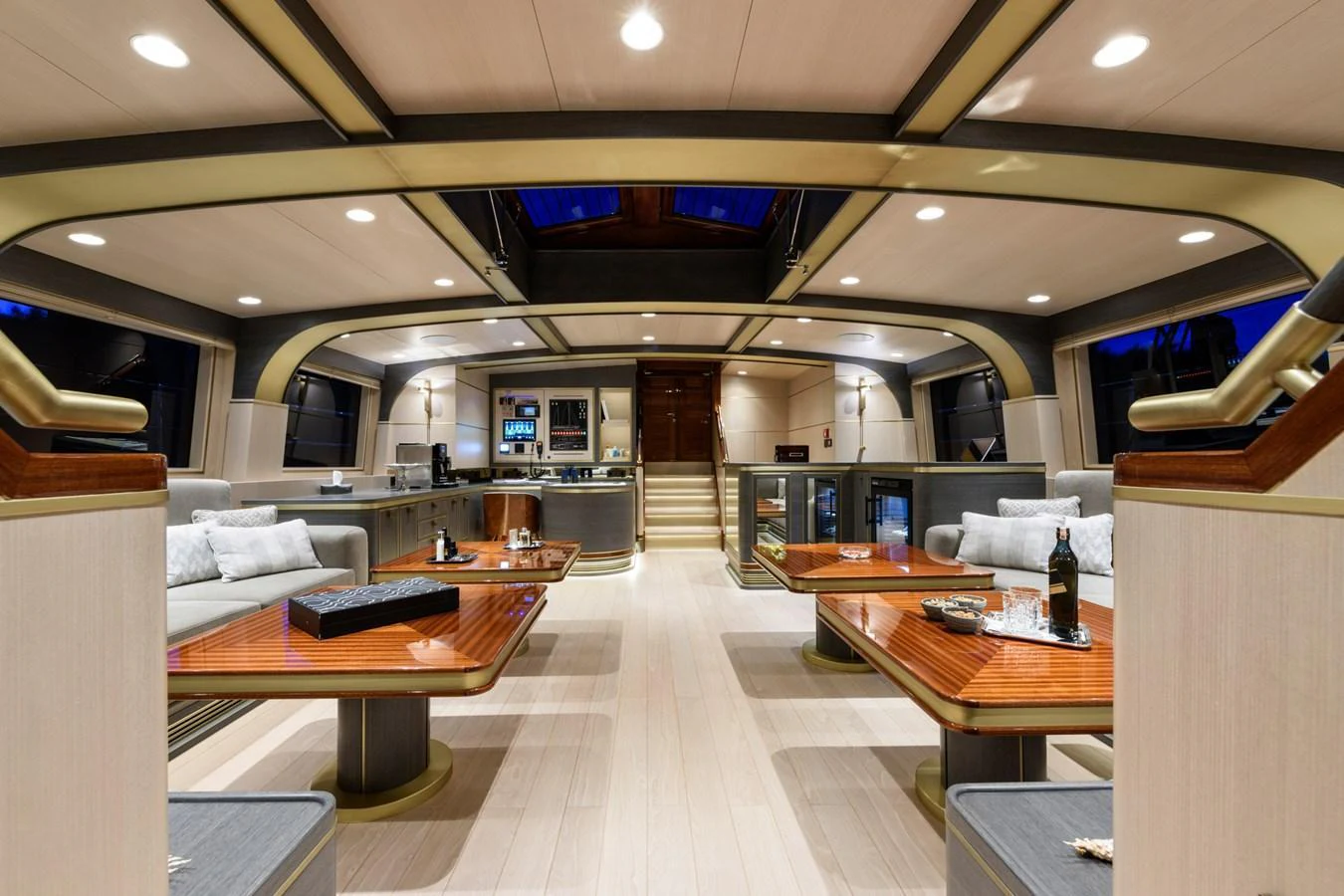 The yacht's salon features luxurious seating, elegant wooden tables, and a sophisticated ambiance. aboard SALLYNA Yacht for Sale