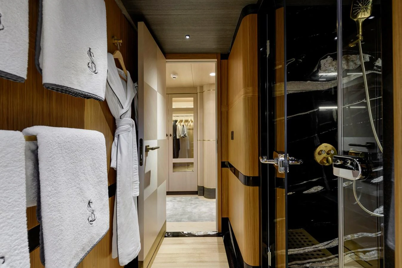 A luxurious yacht bathroom featuring elegant wood paneling and plush towels. aboard SALLYNA Yacht for Sale