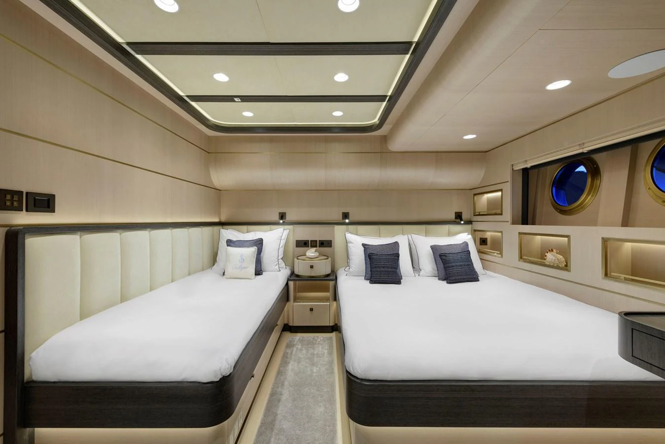The guest stateroom features twin beds with elegant bedding and modern lighting. aboard SALLYNA Yacht for Sale