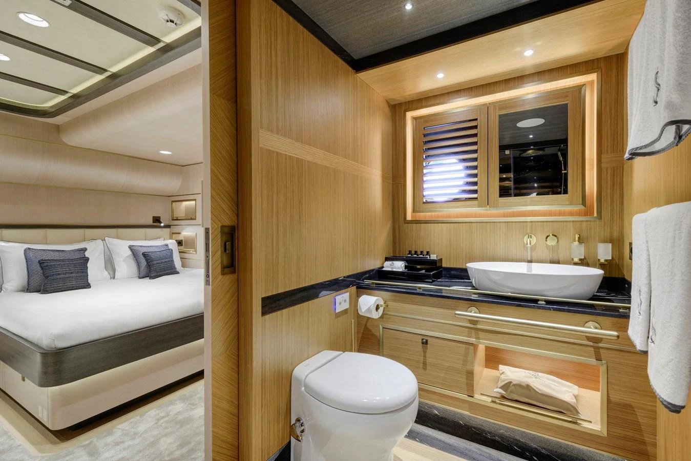 A luxurious yacht bathroom with modern fixtures and a glimpse of the adjacent stateroom. aboard SALLYNA Yacht for Sale