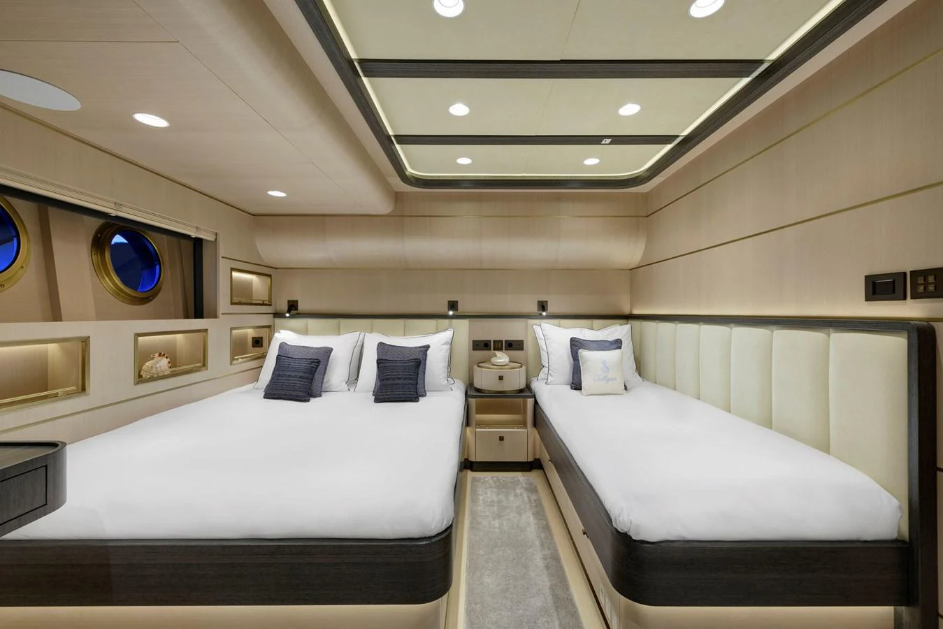 The guest stateroom features two plush beds with elegant bedding and modern lighting. aboard SALLYNA Yacht for Sale
