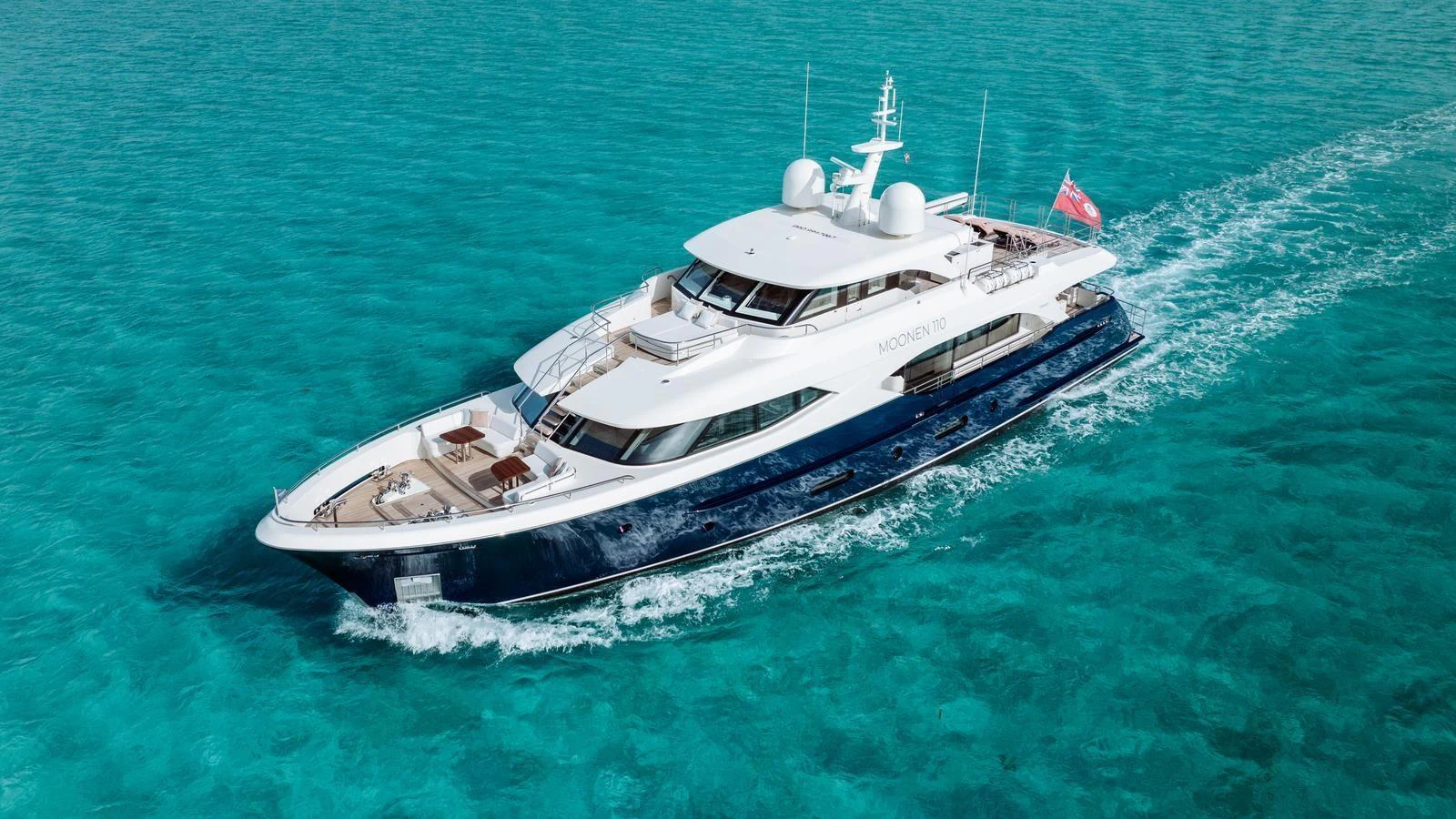 A luxurious yacht cruises through crystal-clear turquoise waters, showcasing its sleek design and elegant profile. aboard MIDNIGHT SAGA Yacht for Sale