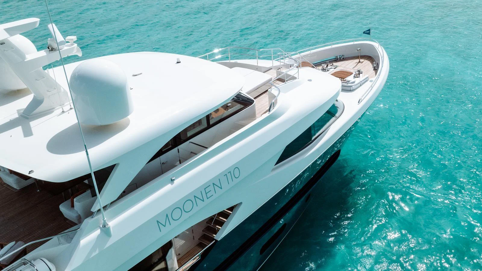 The yacht glides gracefully on clear turquoise waters, showcasing its sleek design and spacious deck areas. aboard MIDNIGHT SAGA Yacht for Sale