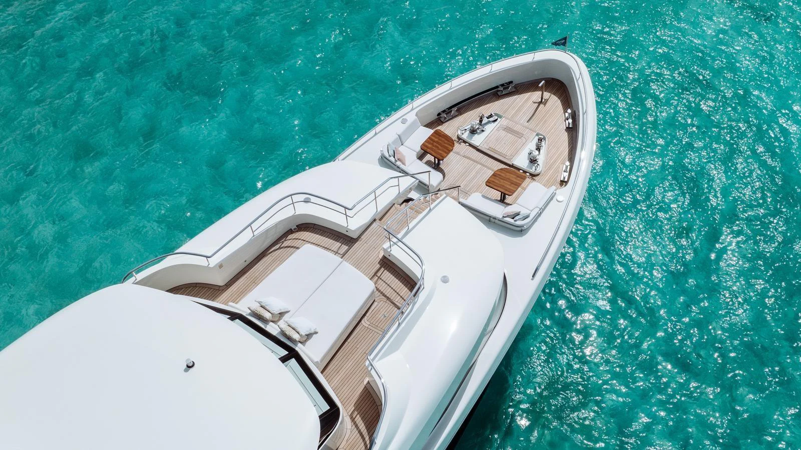 The yacht's foredeck offers a spacious and inviting area for relaxation with stunning views of the clear turquoise water. aboard MIDNIGHT SAGA Yacht for Sale