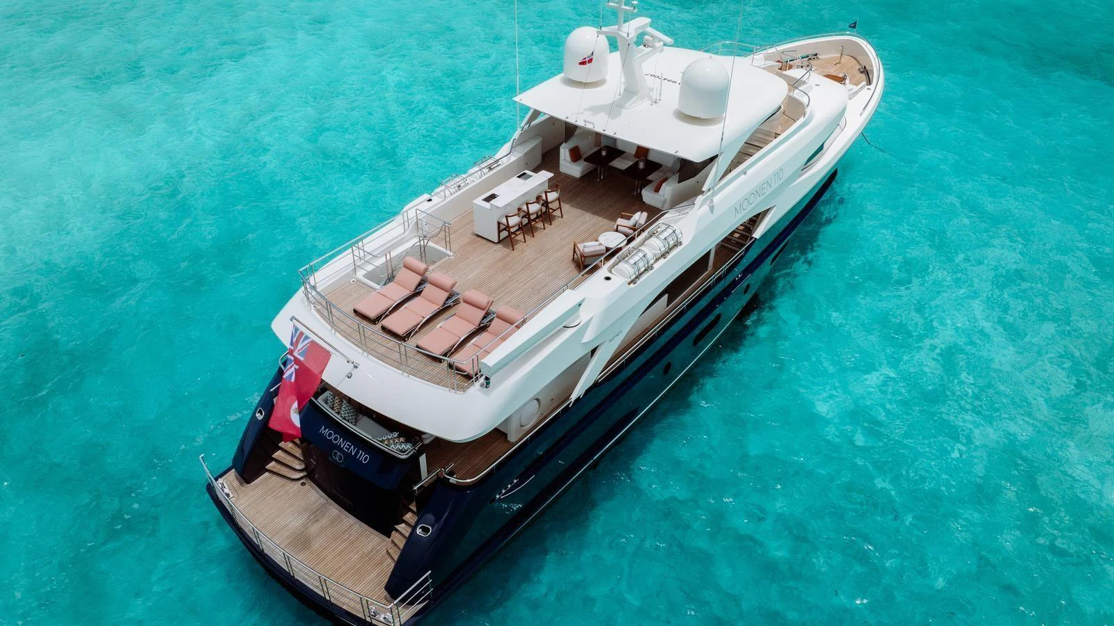 A luxurious yacht with a spacious flybridge cruising on crystal clear waters. aboard MIDNIGHT SAGA Yacht for Sale