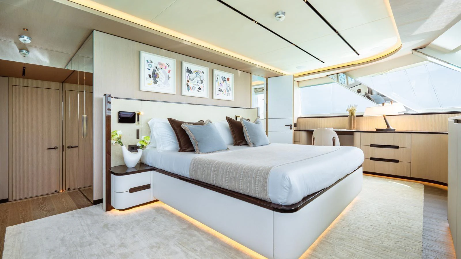 The master stateroom features a luxurious bed, modern decor, and ample natural light. aboard MIDNIGHT SAGA Yacht for Sale