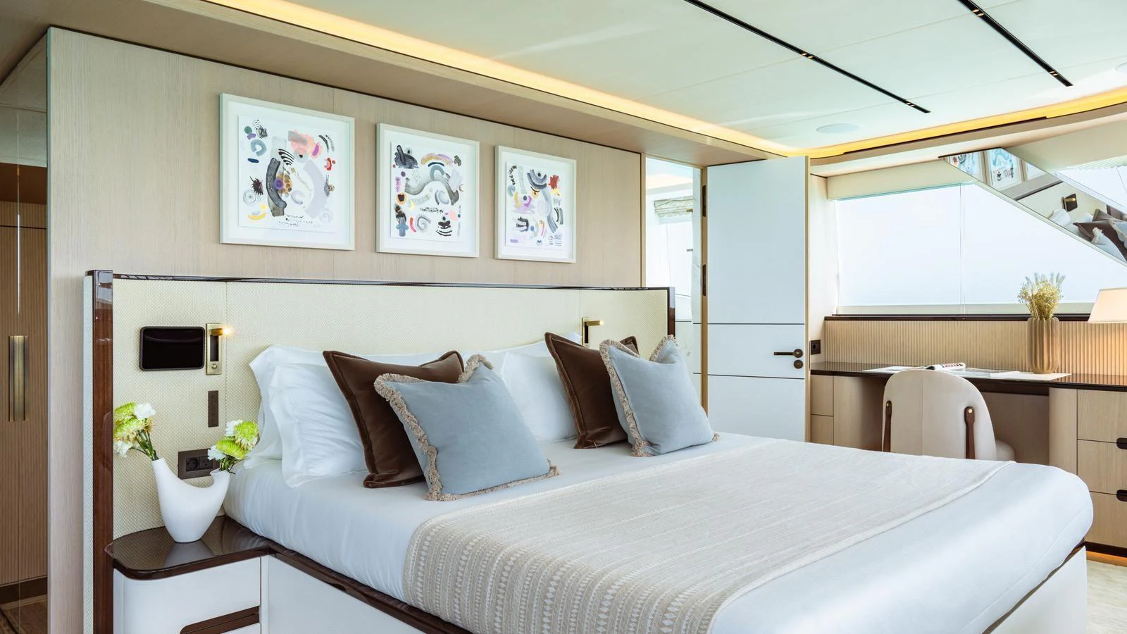 The master stateroom features a luxurious bed with elegant decor and ample natural light. aboard MIDNIGHT SAGA Yacht for Sale