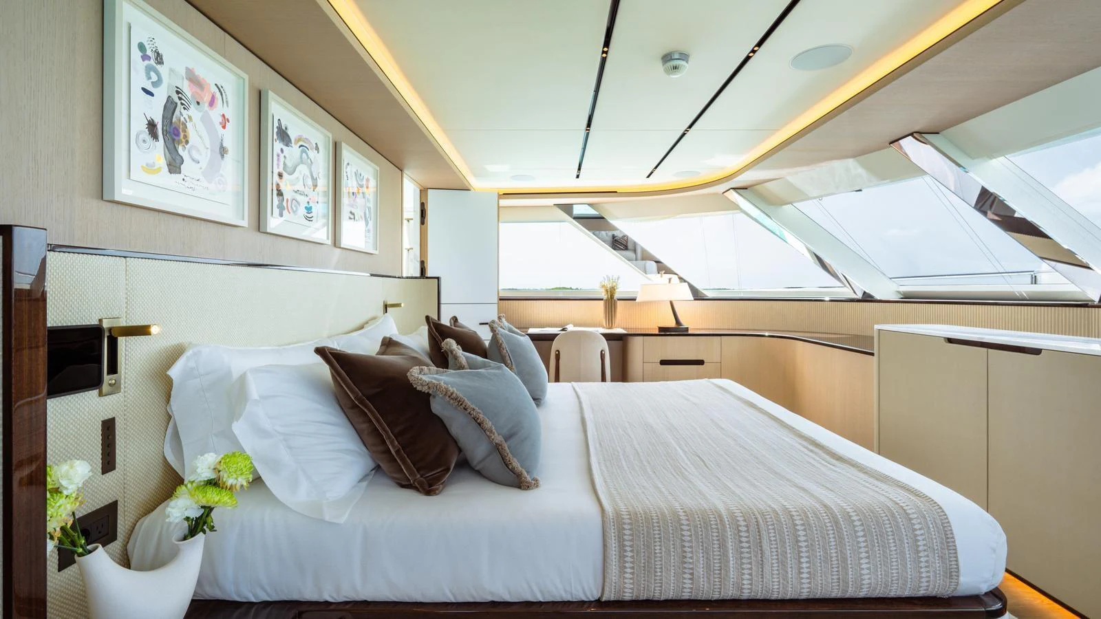 The master stateroom features a luxurious bed with elegant decor and ample natural light. aboard MIDNIGHT SAGA Yacht for Sale