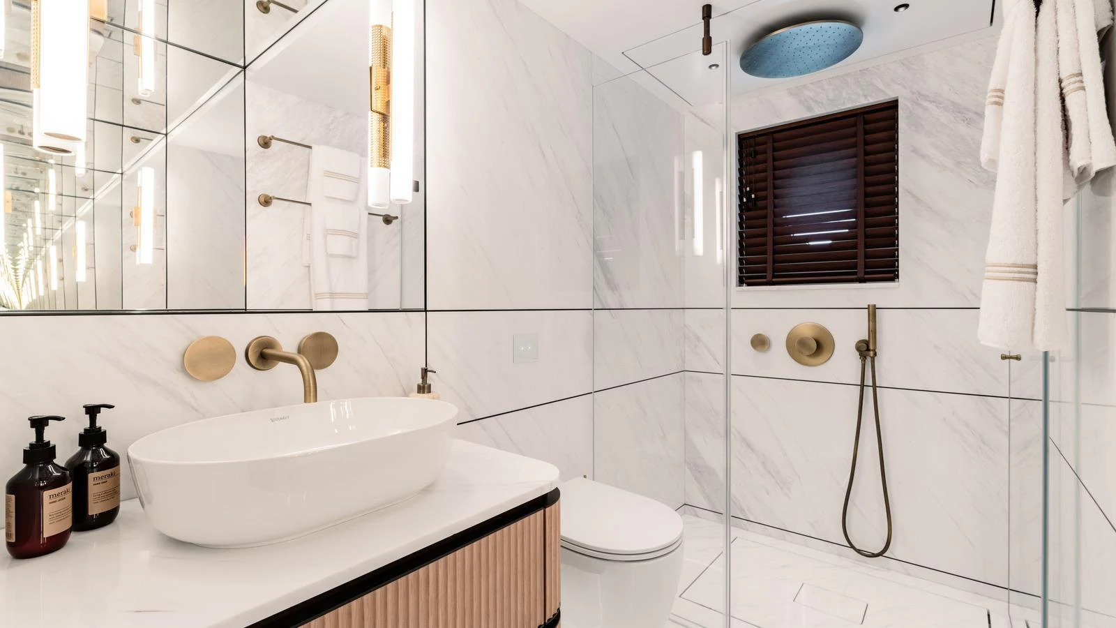The yacht's bathroom features modern fixtures and a luxurious design with marble walls and gold accents. aboard MIDNIGHT SAGA Yacht for Sale