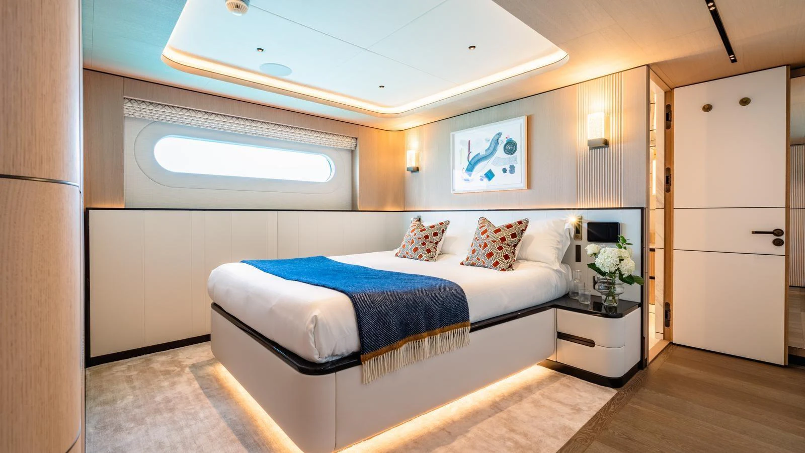 The stateroom features a luxurious bed with elegant lighting and modern decor. aboard MIDNIGHT SAGA Yacht for Sale