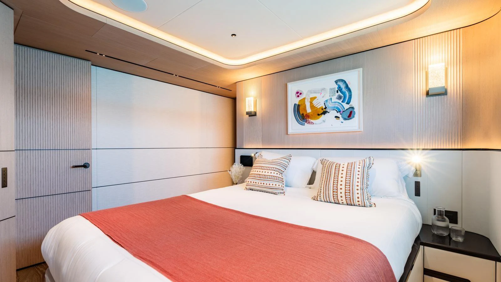 A luxurious stateroom featuring a comfortable bed with stylish decor and ambient lighting. aboard MIDNIGHT SAGA Yacht for Sale