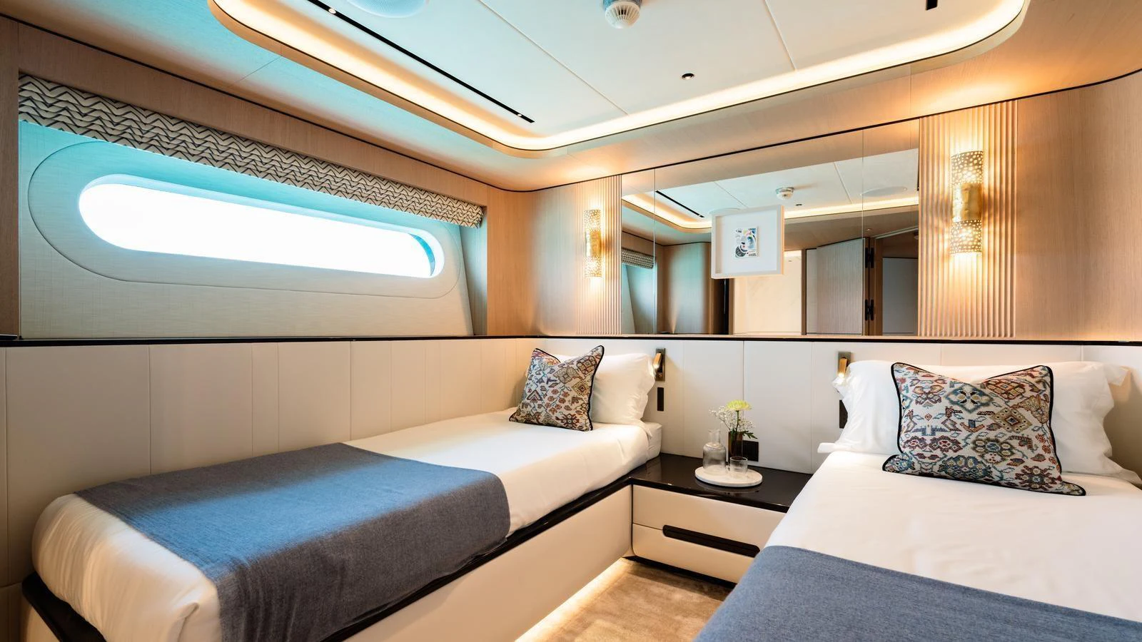 The guest stateroom features twin beds with elegant decor and ample natural light. aboard MIDNIGHT SAGA Yacht for Sale