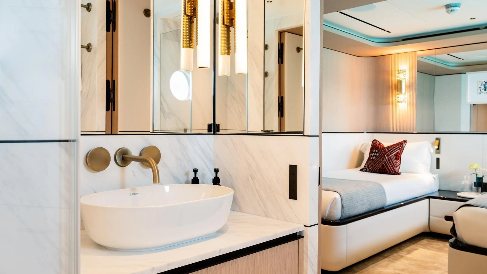 The image showcases a luxurious stateroom with a modern ensuite bathroom. aboard MIDNIGHT SAGA Yacht for Sale