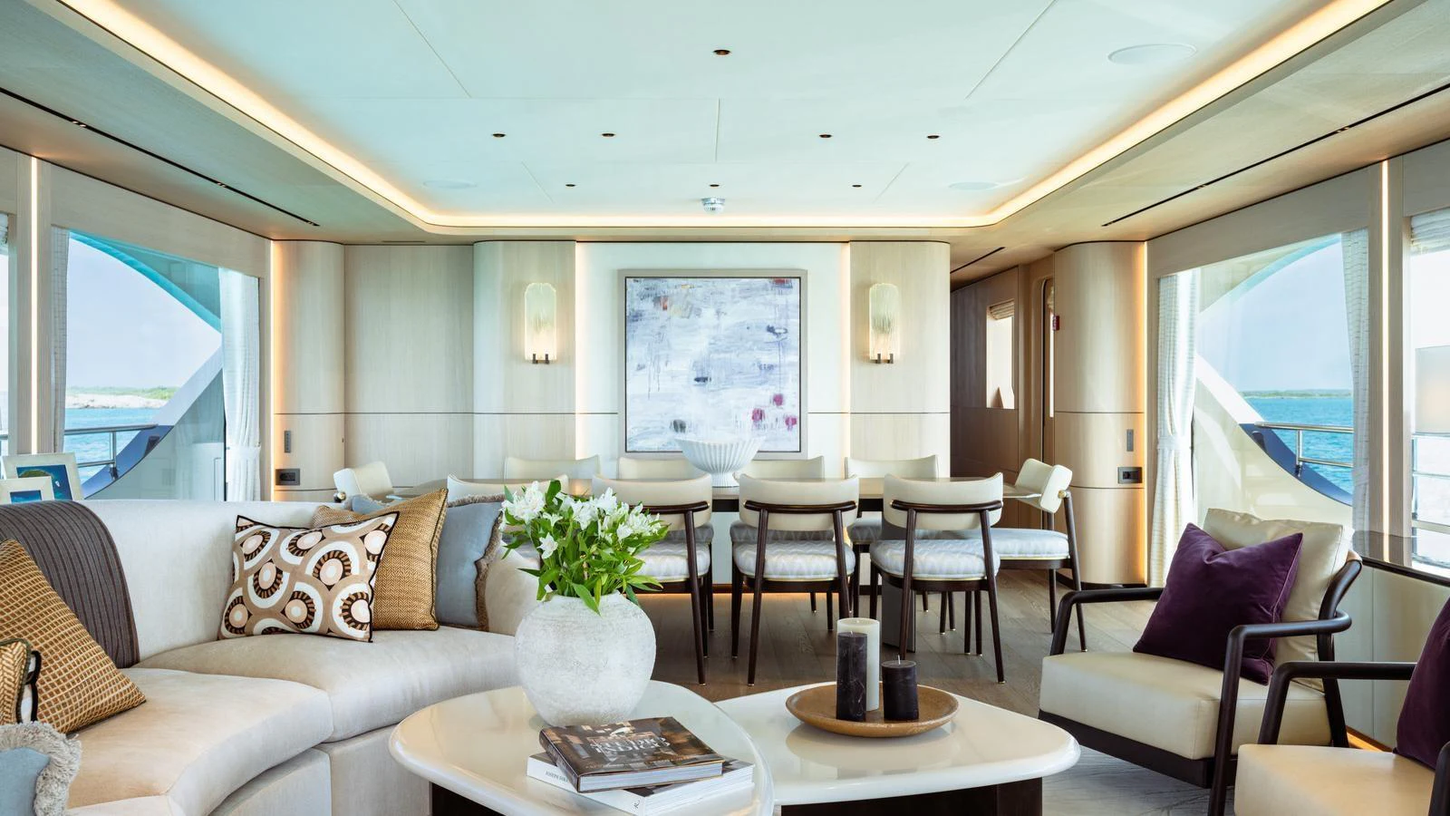 The spacious salon features elegant seating, a dining area, and large windows offering stunning views. aboard MIDNIGHT SAGA Yacht for Sale