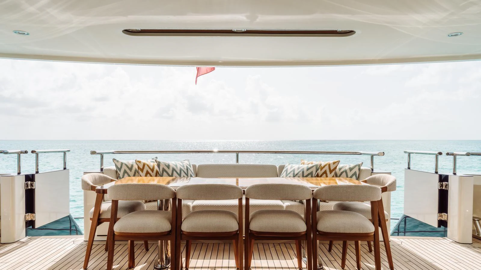 The aft deck features a stylish dining area with a stunning ocean view. aboard MIDNIGHT SAGA Yacht for Sale