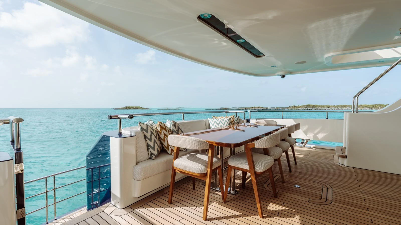 The aft deck features a spacious dining area with stunning ocean views. aboard MIDNIGHT SAGA Yacht for Sale
