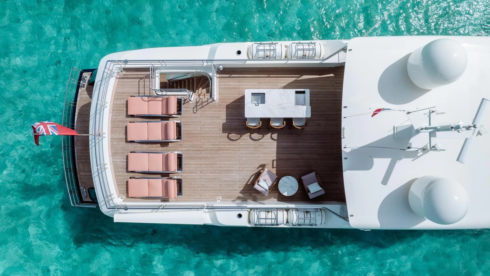 The yacht's sundeck offers a luxurious space with sun loungers and a bar area, perfect for relaxation. aboard MIDNIGHT SAGA Yacht for Sale