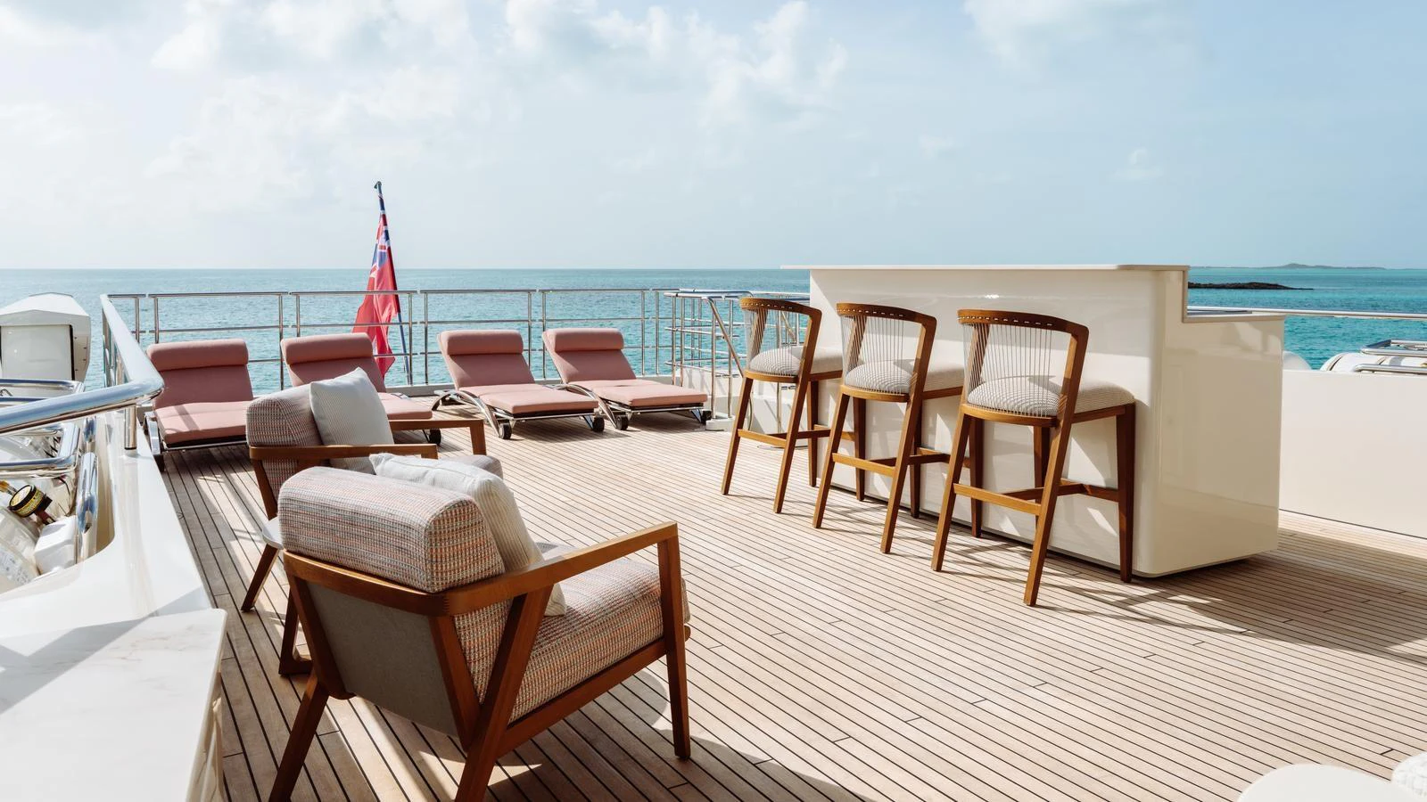 The sundeck features stylish lounge chairs and a bar area, perfect for relaxation and socializing. aboard MIDNIGHT SAGA Yacht for Sale