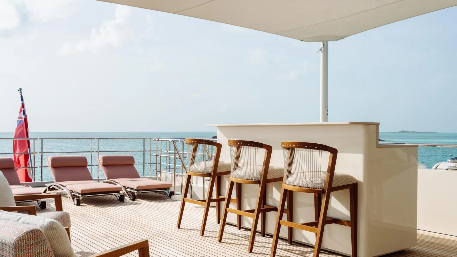 The aft deck features a stylish bar area with comfortable seating and a stunning ocean view. aboard MIDNIGHT SAGA Yacht for Sale