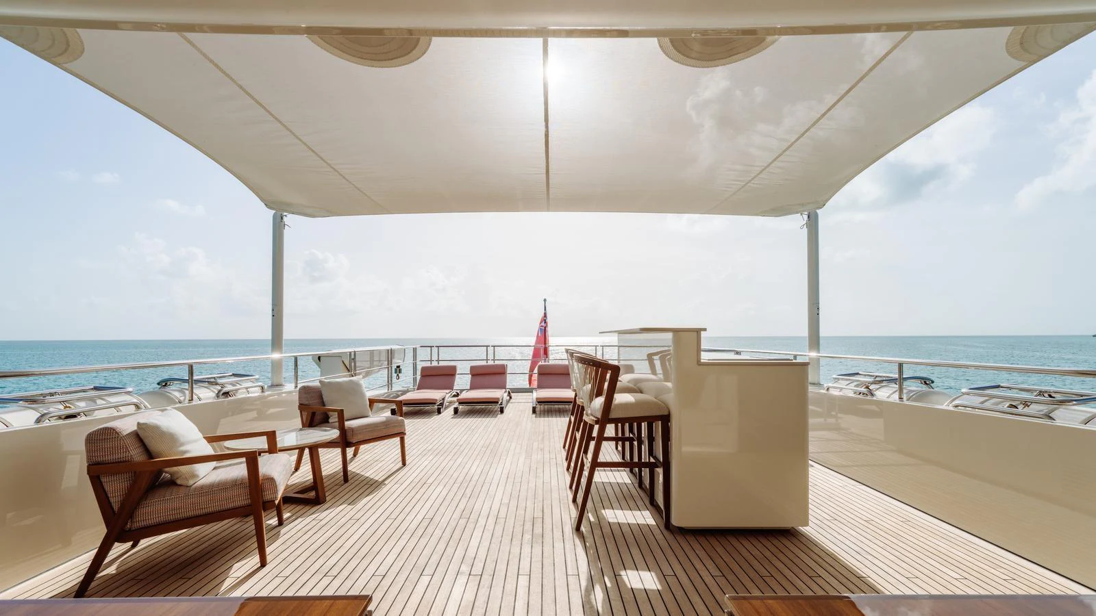 The sundeck offers a luxurious open-air space with comfortable seating and a bar, perfect for relaxation and socializing. aboard MIDNIGHT SAGA Yacht for Sale